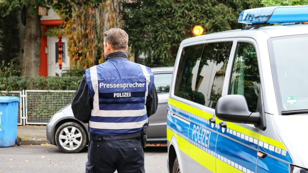 a police officer standing in front of a van