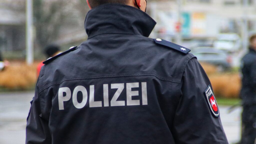 a police officer is standing in the rain